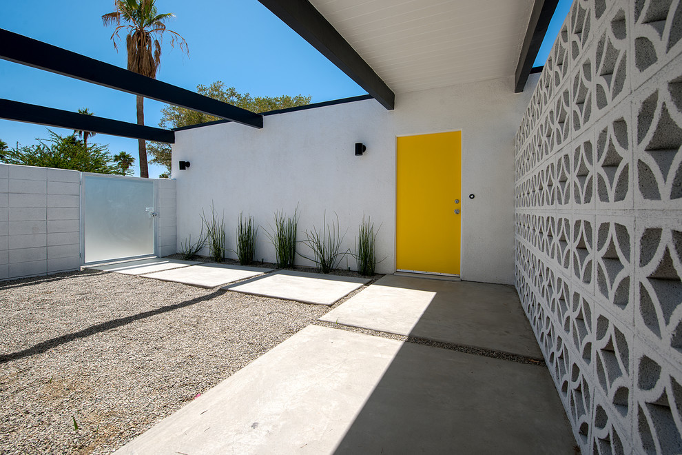 Midcentury entryway in Other with a single front door and a yellow front door.