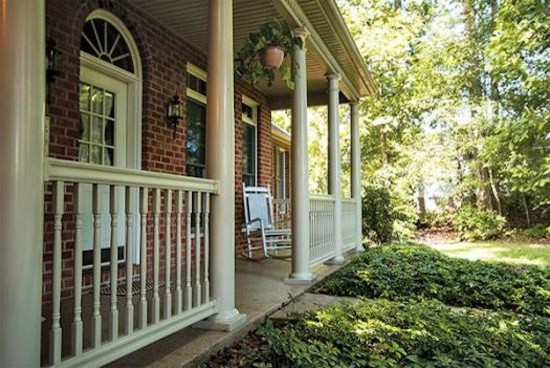 Example of a large backyard deck design with a roof extension