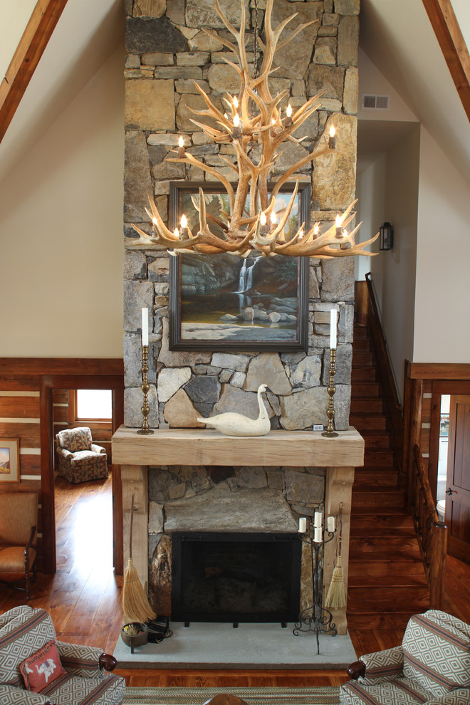 Inspiration for a large rustic formal and loft-style medium tone wood floor living room remodel with a standard fireplace and a stone fireplace