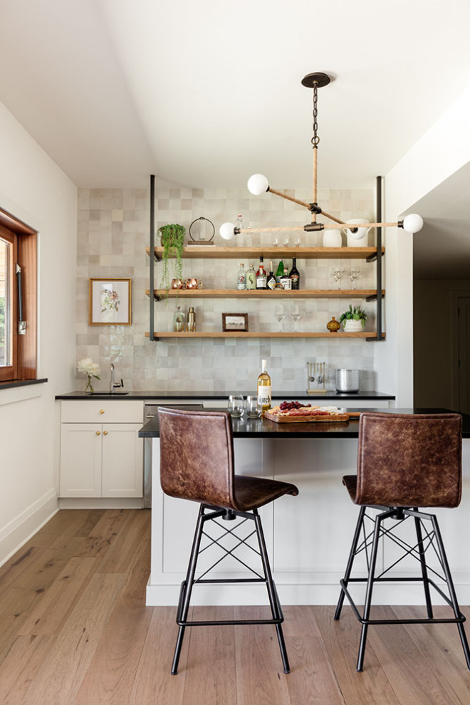 This is an example of a mid-sized contemporary single-wall bar cart in Seattle with an undermount sink, shaker cabinets, white cabinets, quartz benchtops, medium hardwood floors and white benchtop.