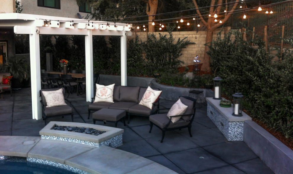 Small modern backyard patio in San Francisco with a fire feature, concrete slab and a pergola.