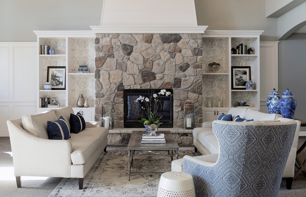 Design ideas for a large transitional open concept living room in Phoenix with a library, grey walls, carpet, a standard fireplace, a stone fireplace surround, no tv and grey floor.
