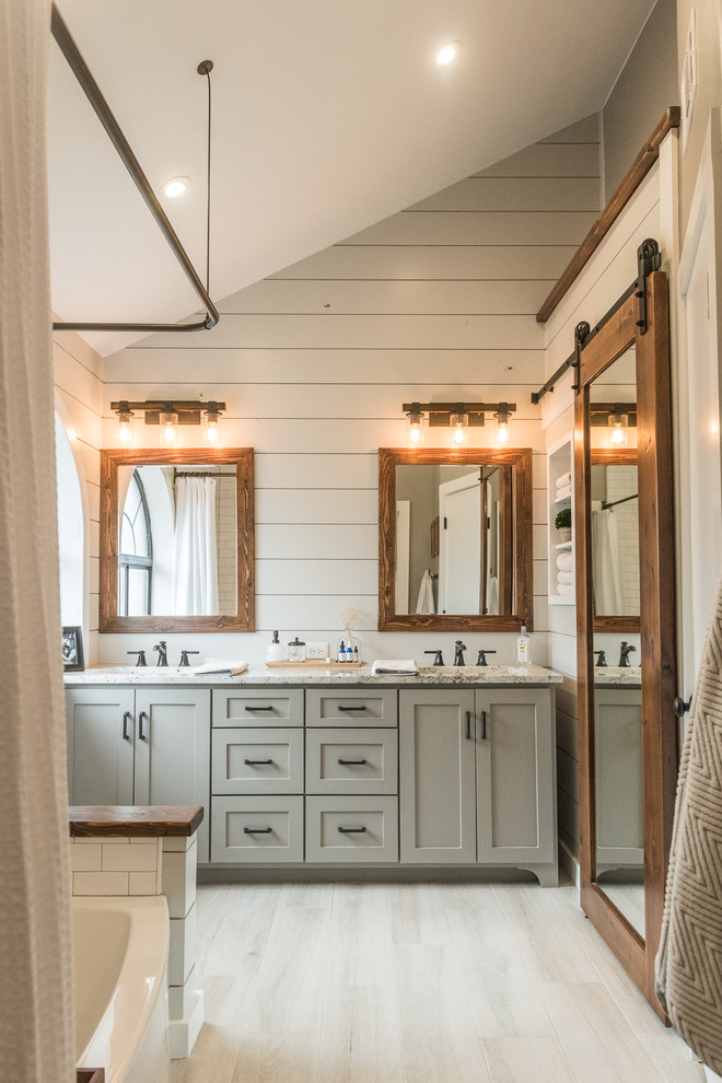Mid-sized cottage master gray tile and porcelain tile porcelain tile alcove bathtub photo in Dallas with shaker cabinets, gray cabinets, a one-piece toilet, gray walls, an undermount sink and granite countertops