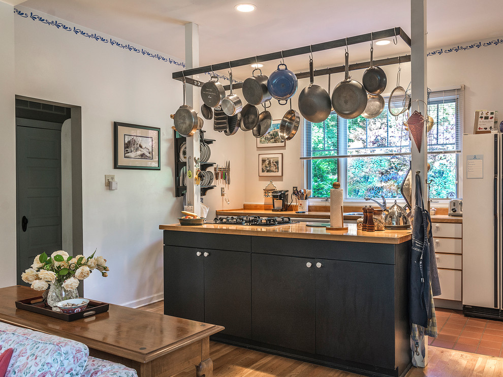 Traditional galley open plan kitchen in DC Metro with a drop-in sink, white appliances and with island.