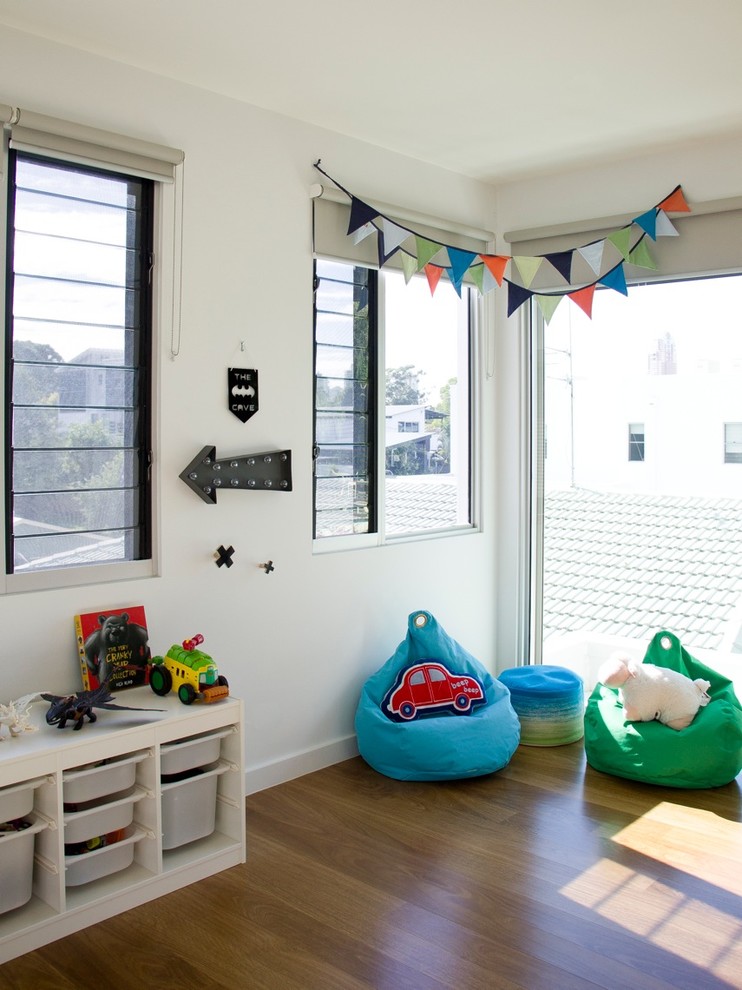 Inspiration for a large contemporary kids' bedroom for kids 4-10 years old and boys in Brisbane with beige walls and light hardwood floors.