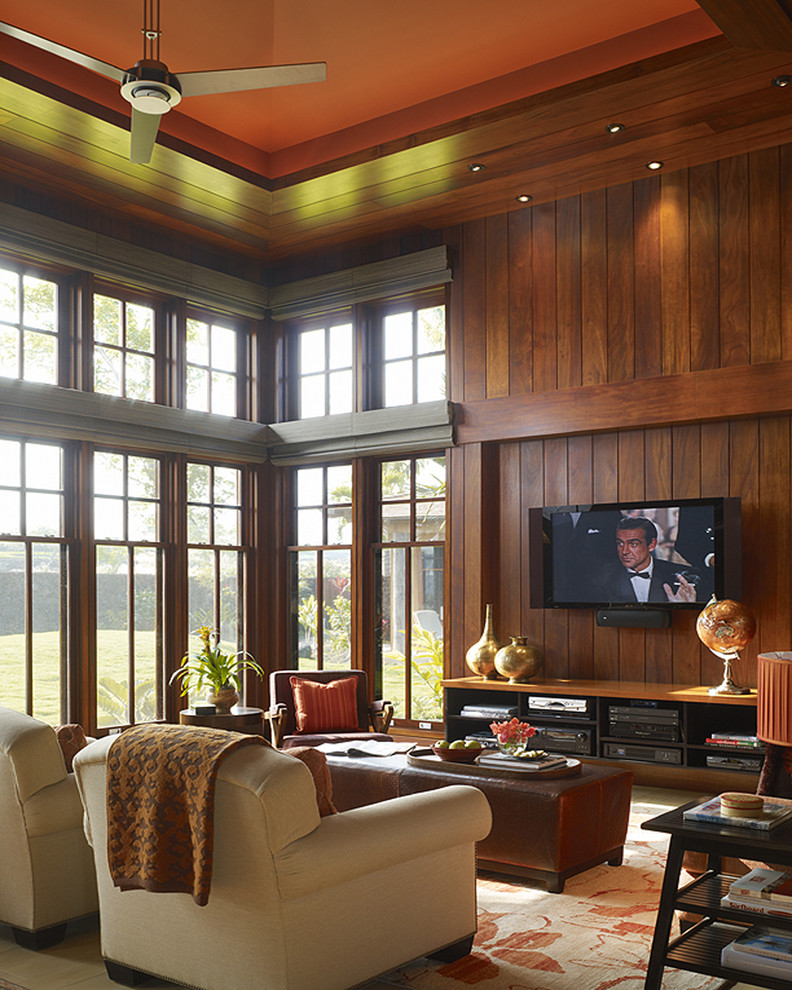 Tropical family room in Hawaii with brown walls and a wall-mounted tv.