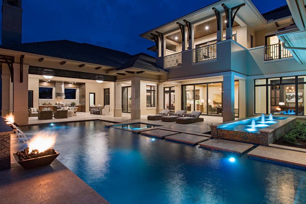 Expansive transitional backyard rectangular pool in Miami with a water feature.