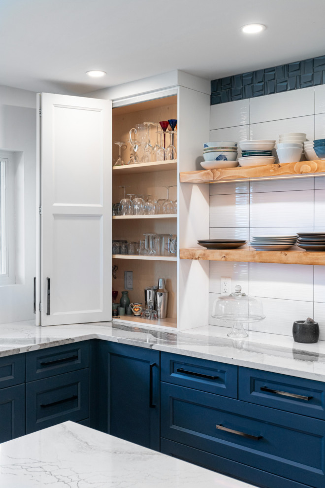 Eat-in kitchen - large transitional u-shaped dark wood floor and brown floor eat-in kitchen idea with an undermount sink, recessed-panel cabinets, blue cabinets, quartz countertops, white backsplash, ceramic backsplash, stainless steel appliances, an island and white countertops