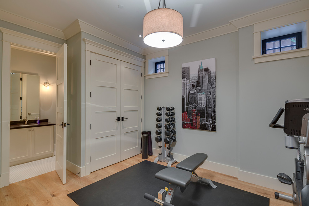 Design ideas for a small arts and crafts home weight room in Vancouver with blue walls and light hardwood floors.