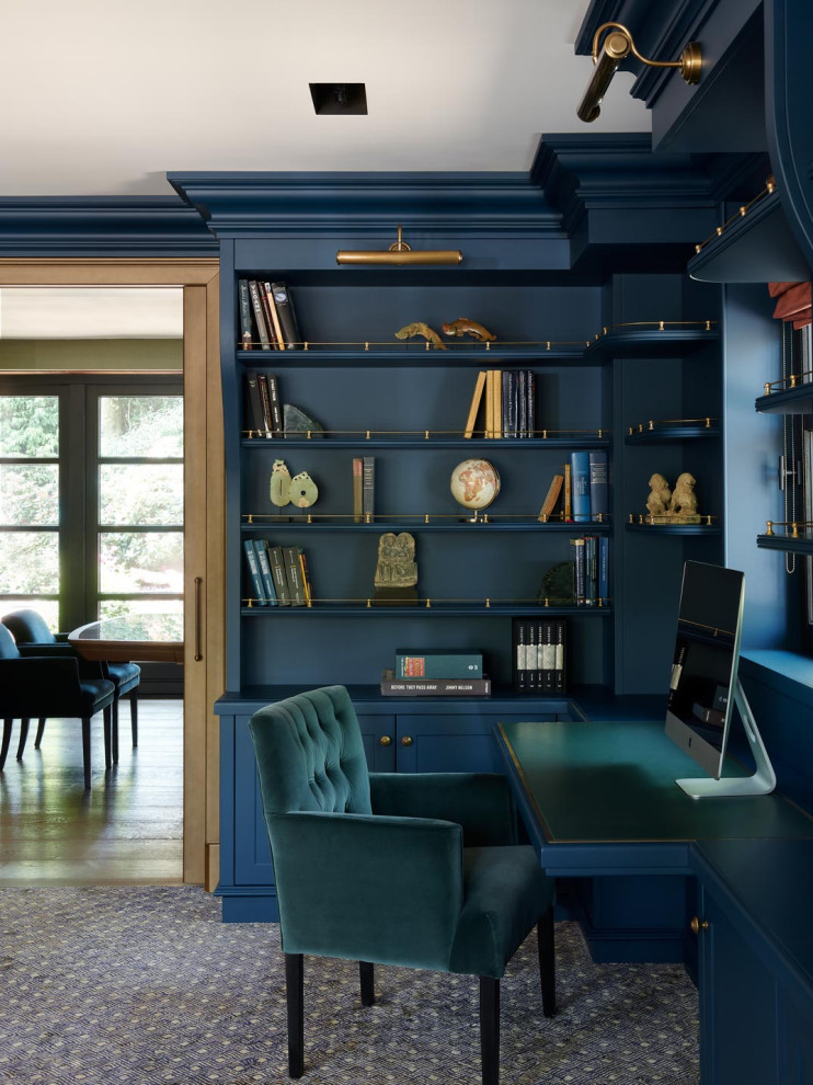На фото: большой кабинет в современном стиле с синими стенами, паркетным полом среднего тона, стандартным камином, фасадом камина из камня, отдельно стоящим рабочим столом, коричневым полом и панелями на части стены