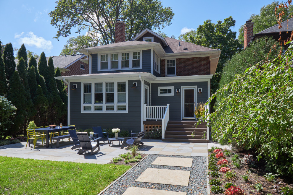 Inspiration for a medium sized and blue classic two floor detached house in Chicago with concrete fibreboard cladding, a hip roof, a shingle roof, a brown roof and shingles.