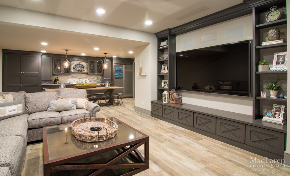 Expansive traditional open concept home theatre with white walls, laminate floors, beige floor and a wall-mounted tv.