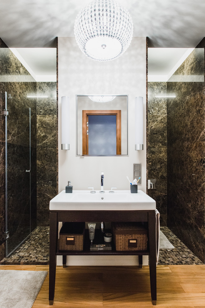Photo of a mid-sized contemporary bathroom in Moscow with open cabinets, dark wood cabinets, a curbless shower, a console sink, brown tile and multi-coloured walls.