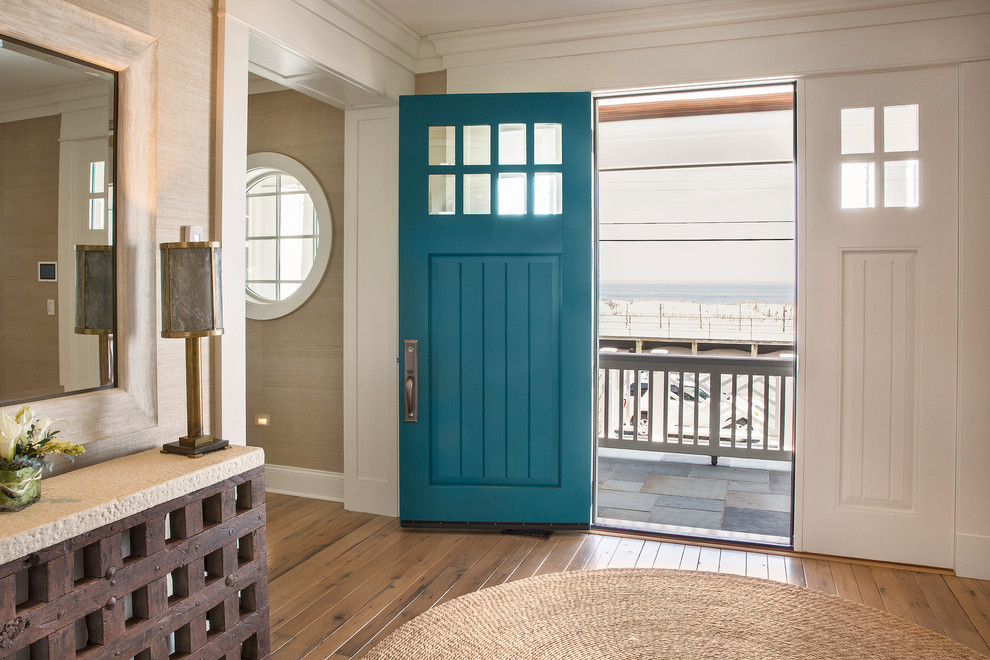 Mid-sized beach style front door in New York with medium hardwood floors, a single front door, a blue front door and beige walls.