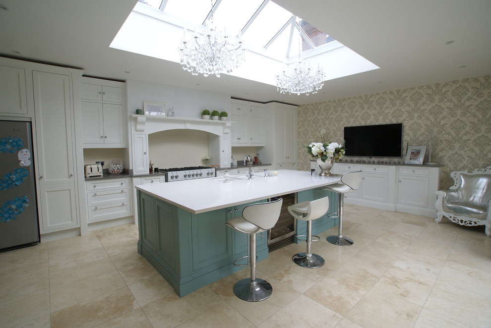This is an example of a traditional kitchen in Essex with an undermount sink, recessed-panel cabinets, white cabinets, beige splashback, stainless steel appliances and with island.