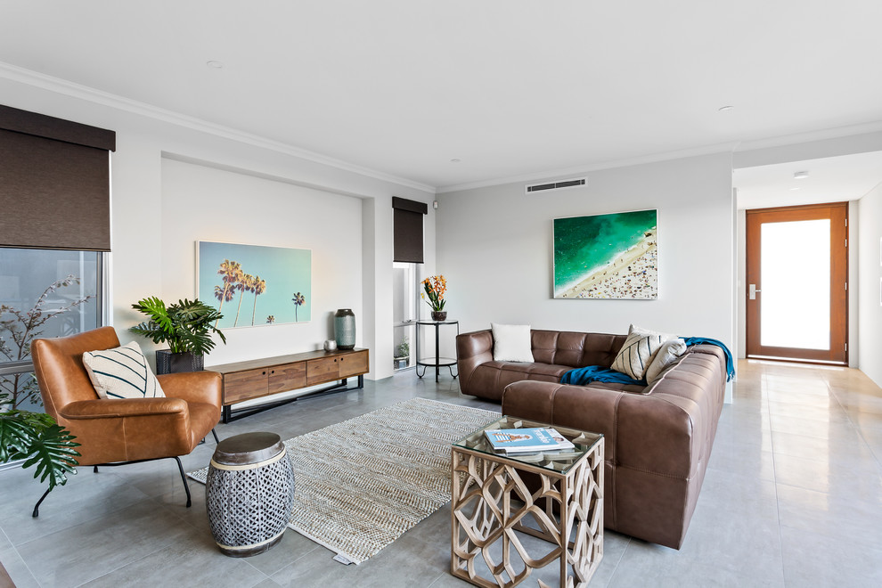 This is an example of a beach style formal open concept living room in Perth with grey walls, no fireplace, no tv and grey floor.