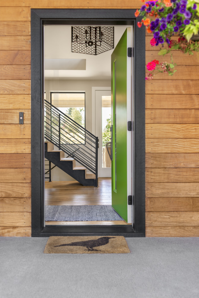 Foyer - mid-sized transitional light wood floor foyer idea in Seattle with beige walls and a green front door