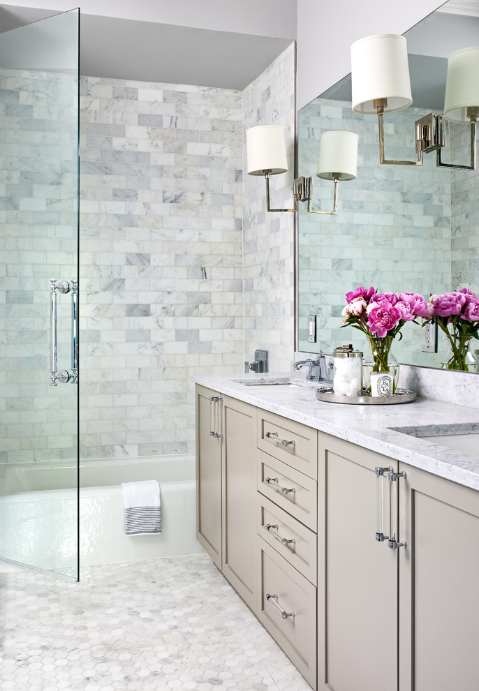Inspiration for a traditional bathroom in Los Angeles with recessed-panel cabinets, beige cabinets, an alcove tub, a shower/bathtub combo, gray tile, white tile, subway tile, grey walls, mosaic tile floors, white floor, a hinged shower door and grey benchtops.