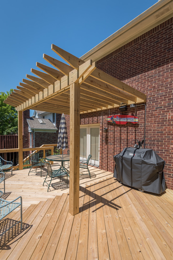 Design ideas for a mid-sized traditional backyard deck in Louisville with a pergola.