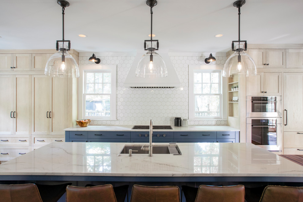 This is an example of an expansive transitional single-wall eat-in kitchen in Minneapolis with an undermount sink, blue cabinets, granite benchtops, white splashback, ceramic splashback, panelled appliances, medium hardwood floors, with island, blue benchtop and shaker cabinets.