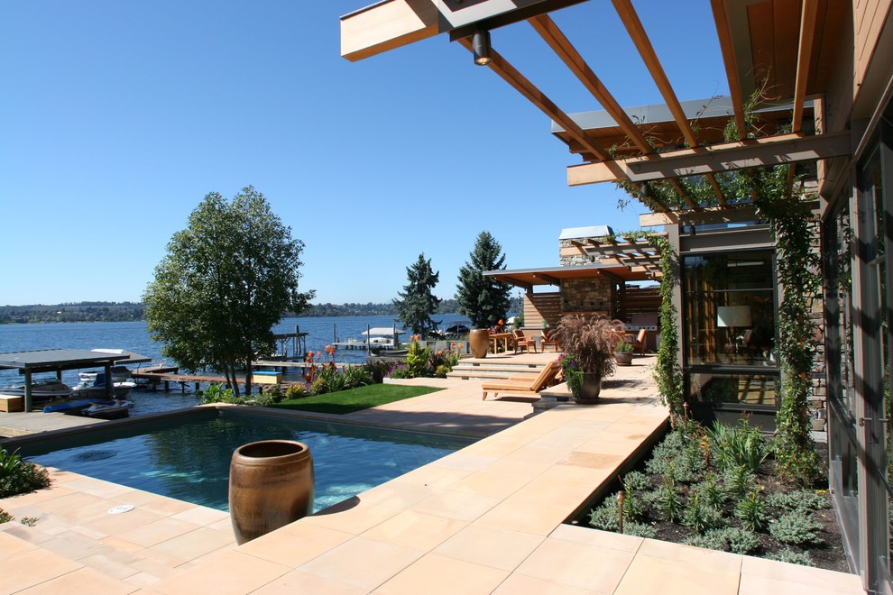 Photo of a large contemporary backyard rectangular lap pool in Seattle with a hot tub and concrete pavers.