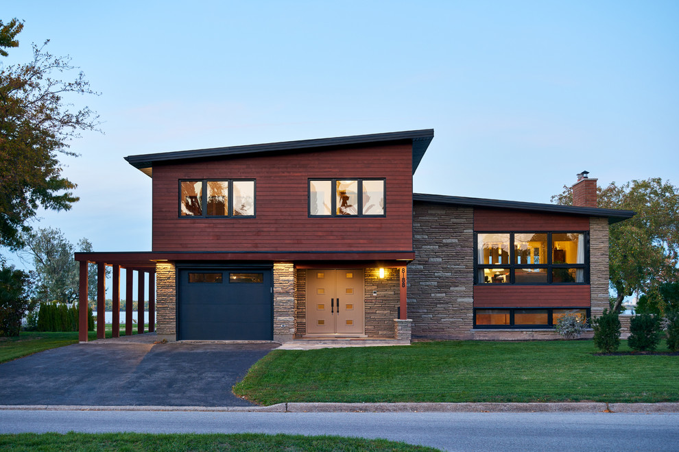 Inspiration for a mid-sized contemporary two-storey brown exterior in Toronto with mixed siding and a flat roof.