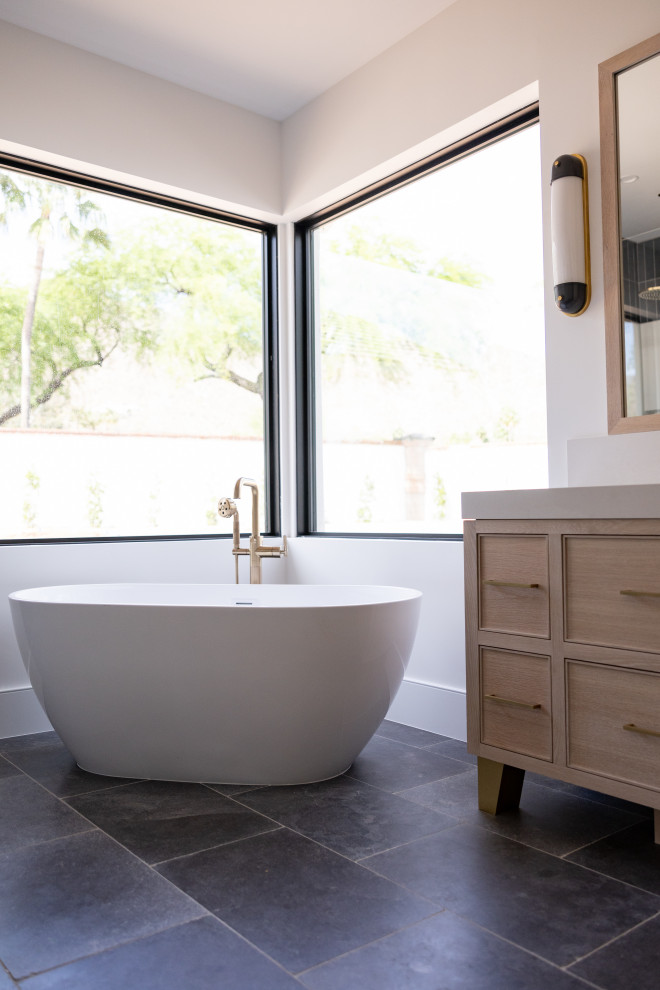 Large transitional master white tile and porcelain tile porcelain tile, gray floor, double-sink, coffered ceiling and wainscoting freestanding bathtub photo in Phoenix with recessed-panel cabinets, light wood cabinets, a bidet, white walls, an undermount sink, marble countertops, a hinged shower door, white countertops, a niche and a freestanding vanity