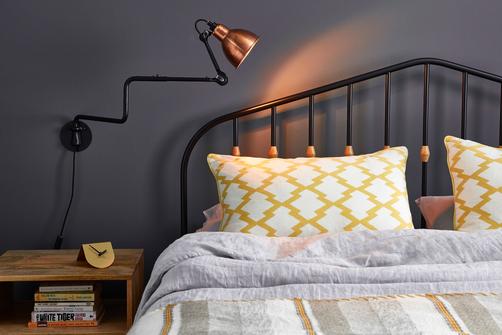 Industrial guest bedroom in London with grey walls.