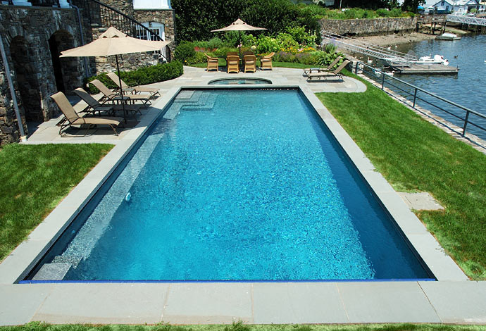 Idee per una piscina stile marino rettangolare con pavimentazioni in pietra naturale