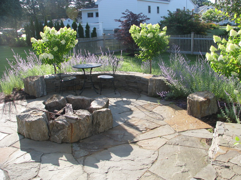 This is an example of a traditional patio in Portland Maine with a fire feature.