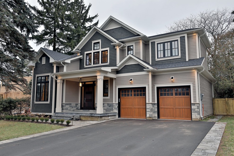 Photo of a mid-sized transitional two-storey beige exterior.