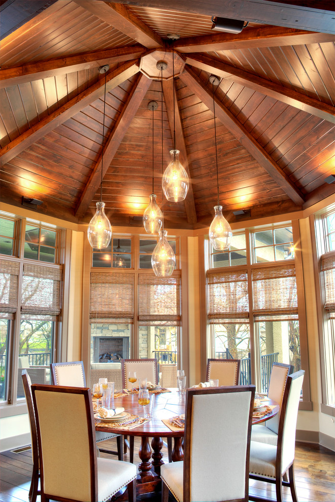 Inspiration for a country dining room in Kansas City with medium hardwood floors.