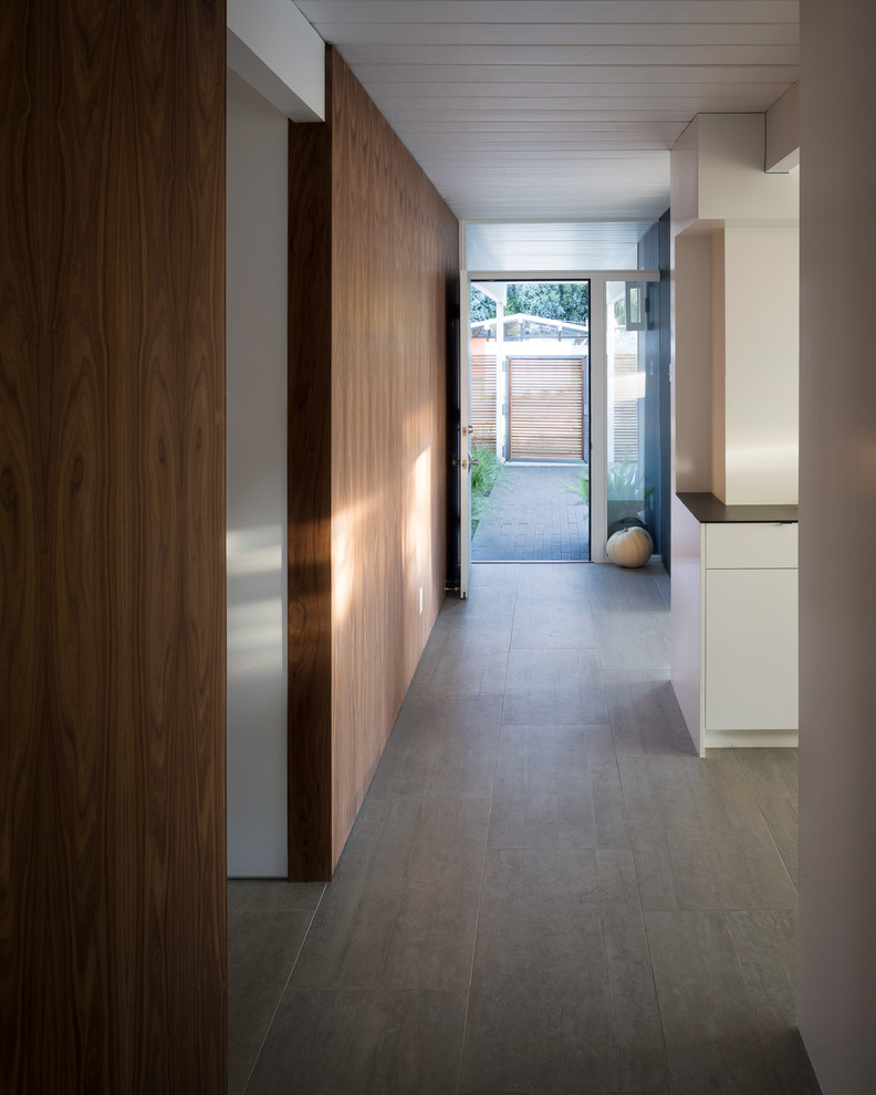Design ideas for a mid-sized midcentury hallway in San Francisco with white walls, porcelain floors, grey floor and wood.