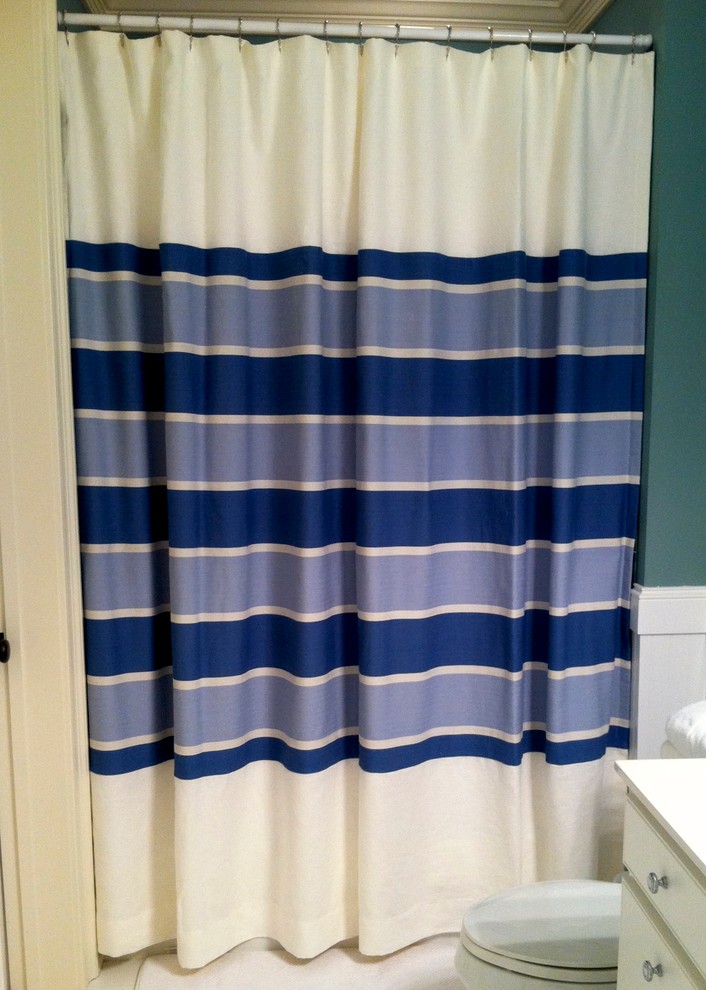 Inspiration for a mid-sized transitional kids' ceramic tile tub/shower combo remodel with flat-panel cabinets, white cabinets, a one-piece toilet and blue walls