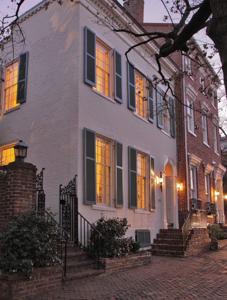 Mid-sized traditional two-storey brick white townhouse exterior in Baltimore.