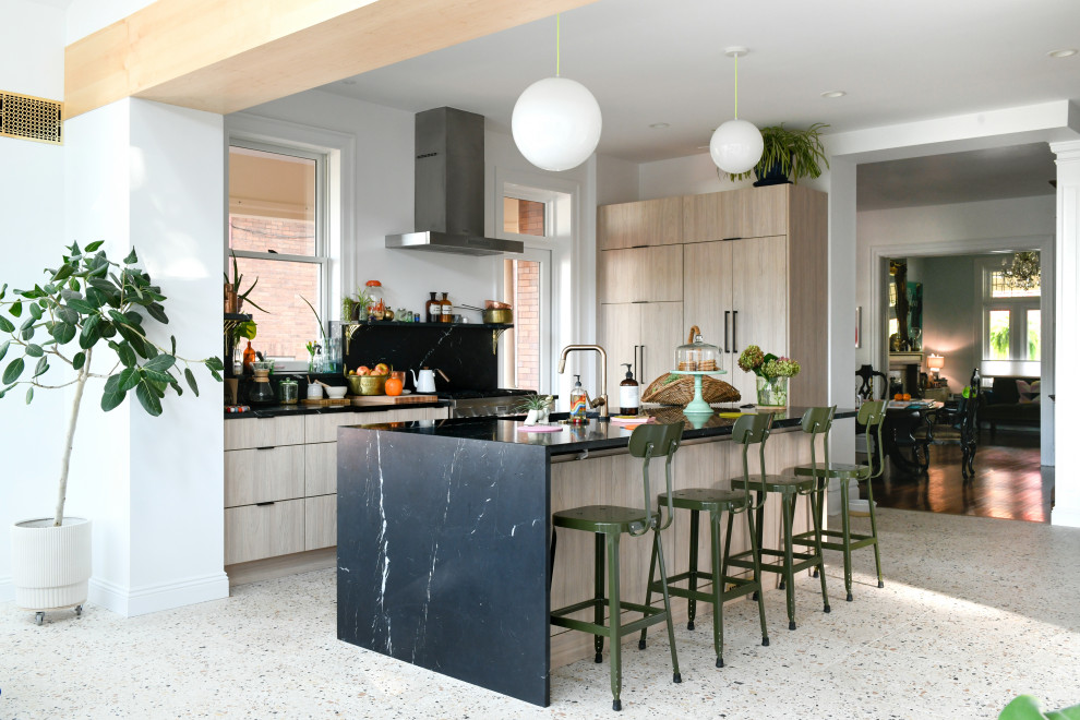 Design ideas for a midcentury open plan kitchen in Other with flat-panel cabinets, light wood cabinets, marble benchtops, black splashback, marble splashback, stainless steel appliances, terrazzo floors and with island.