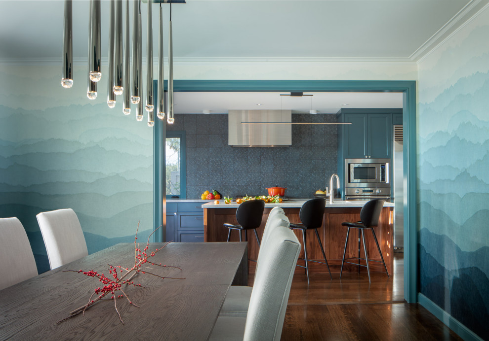 Huge trendy medium tone wood floor and wallpaper kitchen/dining room combo photo in San Francisco with blue walls