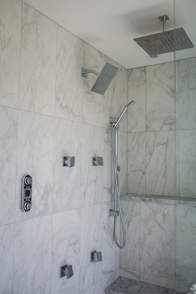 Design ideas for a mid-sized contemporary master wet room bathroom in Omaha with a hot tub, white tile, marble, white walls, porcelain floors, white floor, a hinged shower door and a shower seat.