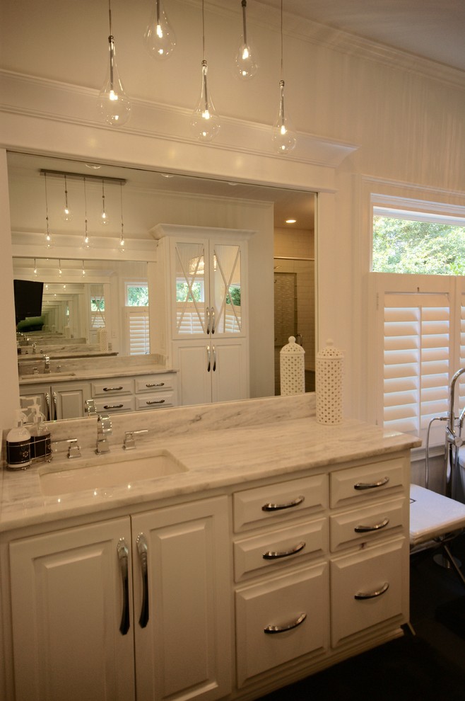 Contemporary master bathroom in Atlanta with an undermount sink, raised-panel cabinets, white cabinets, marble benchtops, a freestanding tub, a corner shower, white walls and ceramic floors.