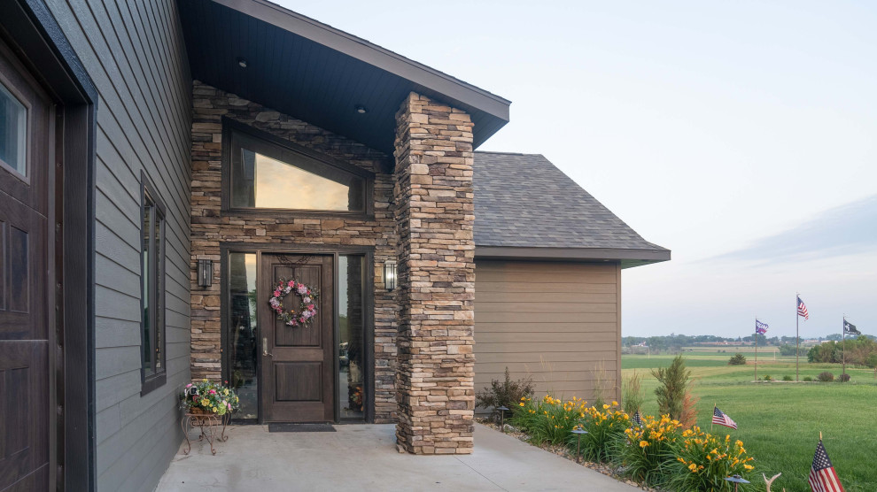 Front door - large transitional concrete floor, gray floor and vaulted ceiling front door idea with gray walls and a dark wood front door