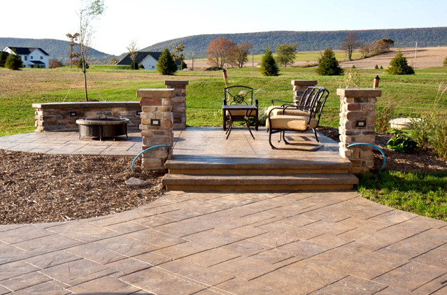 This is an example of a small traditional backyard patio in Philadelphia with a fire feature.