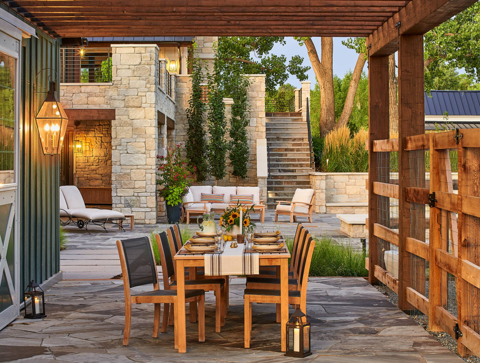 Photo of an expansive country backyard patio in Denver with a pergola.