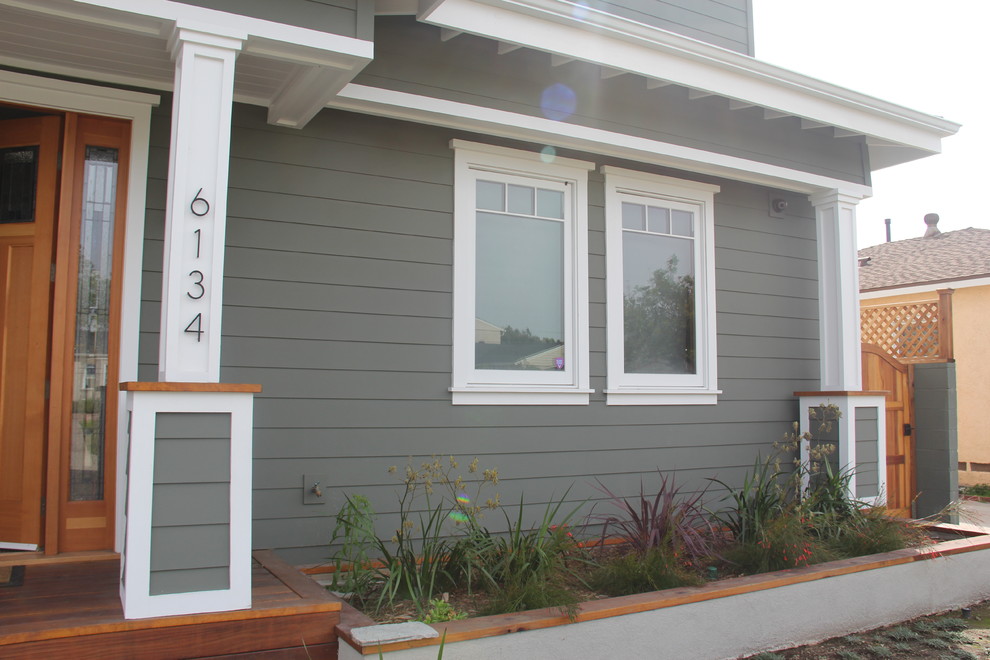 This is an example of a mid-sized traditional two-storey grey exterior in Los Angeles with wood siding.