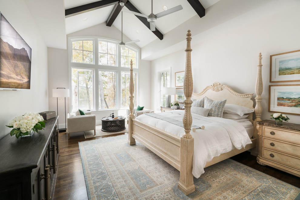 This is an example of a traditional bedroom in Other with white walls, dark hardwood floors and brown floor.