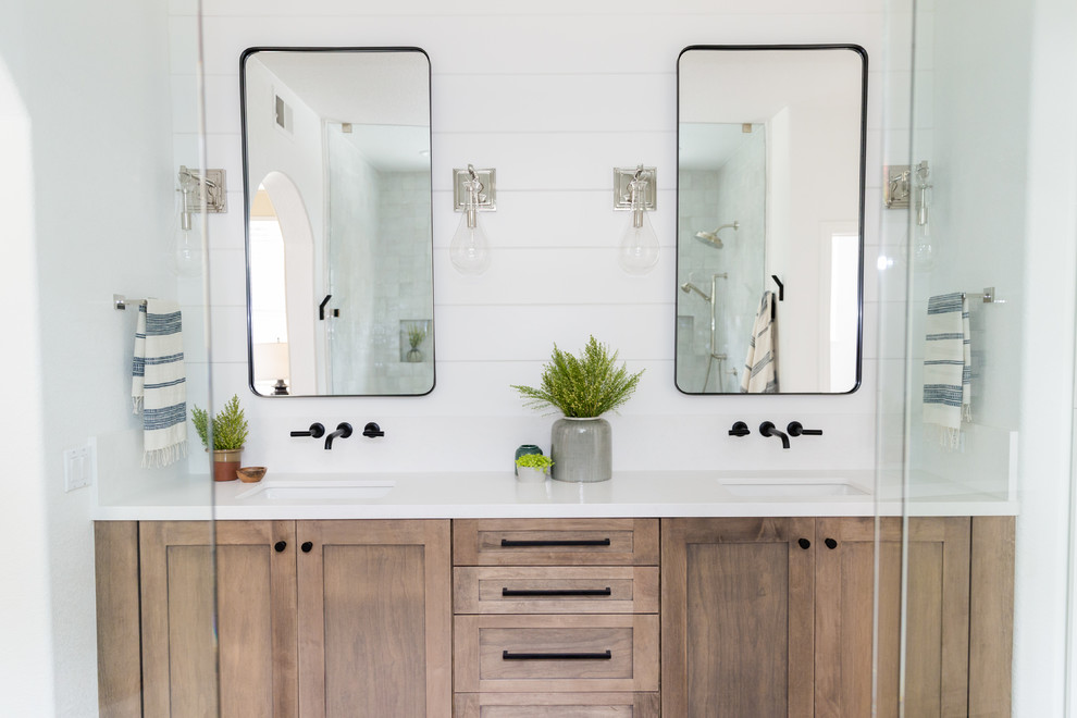 Design ideas for a mid-sized country master bathroom in San Diego with shaker cabinets, medium wood cabinets, a double shower, a two-piece toilet, white tile, terra-cotta tile, white walls, travertine floors, an undermount sink, engineered quartz benchtops, beige floor and a hinged shower door.