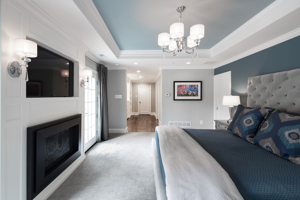 Inspiration for a mid-sized transitional master bedroom in Philadelphia with grey walls, carpet, a standard fireplace, a wood fireplace surround and grey floor.