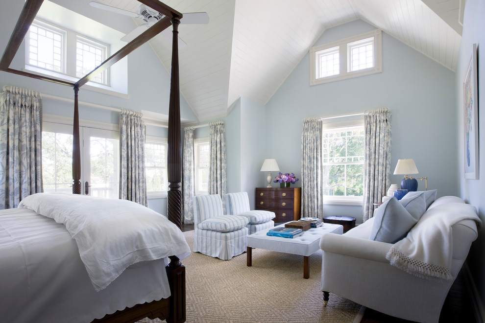 Traditional master bedroom in New York with blue walls, dark hardwood floors and no fireplace.