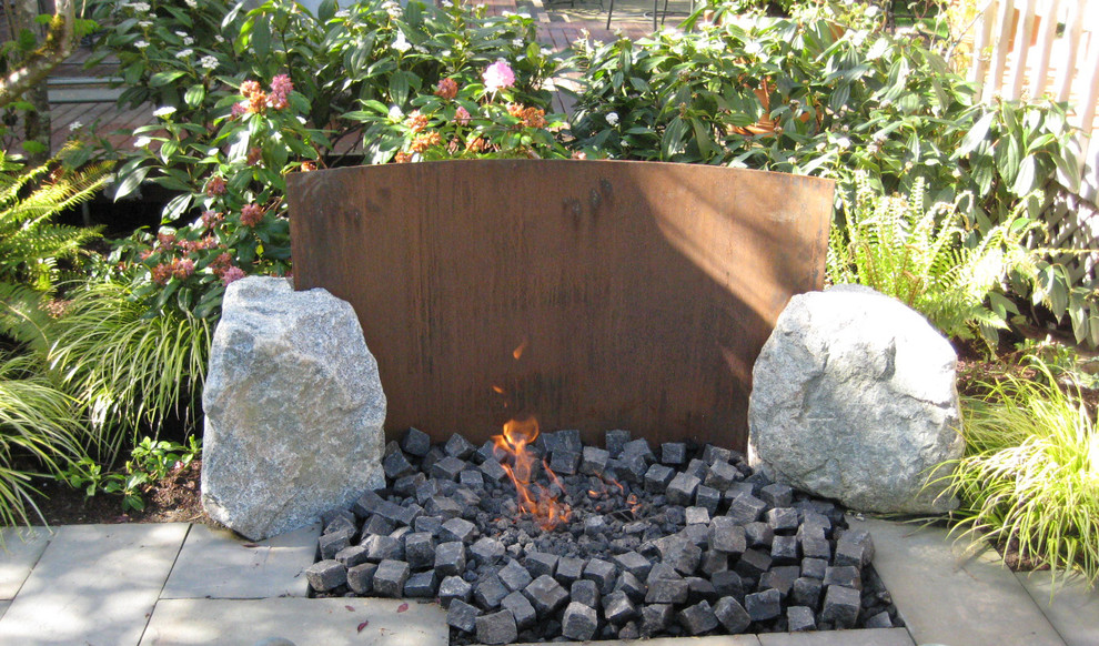 Inspiration for a mid-sized modern backyard shaded garden in Seattle with a fire feature and concrete pavers.