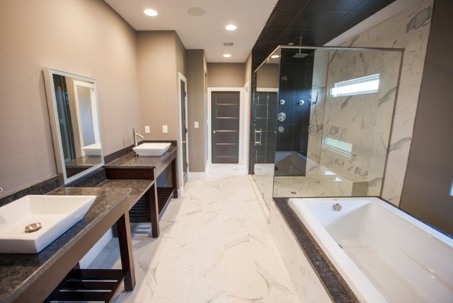 Photo of a large modern master bathroom in Other with open cabinets, dark wood cabinets, a drop-in tub, an open shower, stone tile, beige walls, marble floors, a vessel sink and granite benchtops.