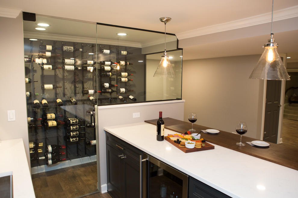 Mid-sized transitional wine cellar in Chicago with medium hardwood floors, storage racks and brown floor.